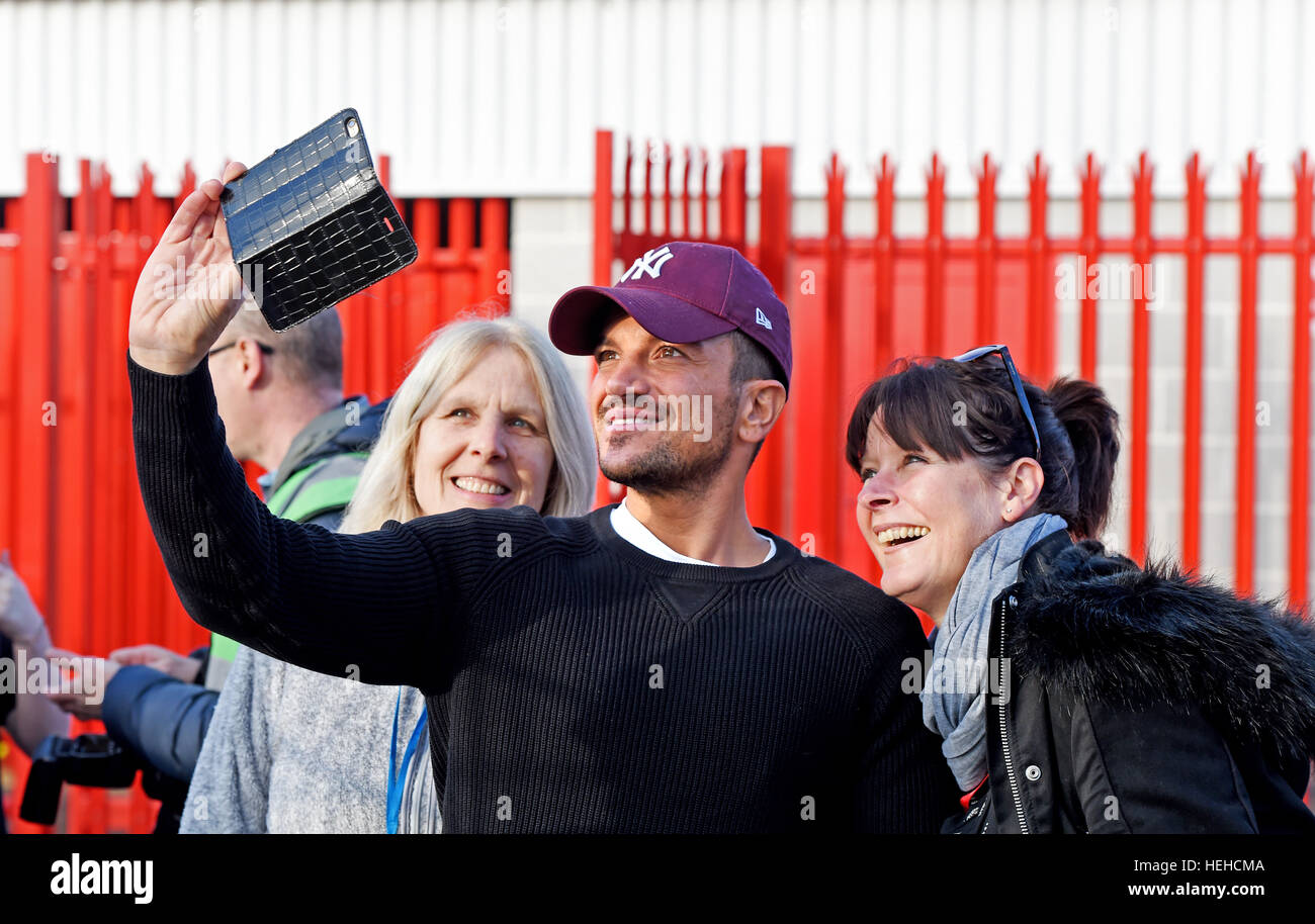 TV personality Peter Andre poses for photographs with fans before the Sky Bet League 2 match between Crawley Town and Newport County at the Checkatrade Stadium in Crawley. December 17, 2016. Stock Photo