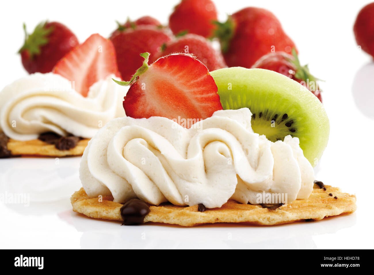 Waffle topped with whipped cream, strawberry and kiwi Stock Photo - Alamy