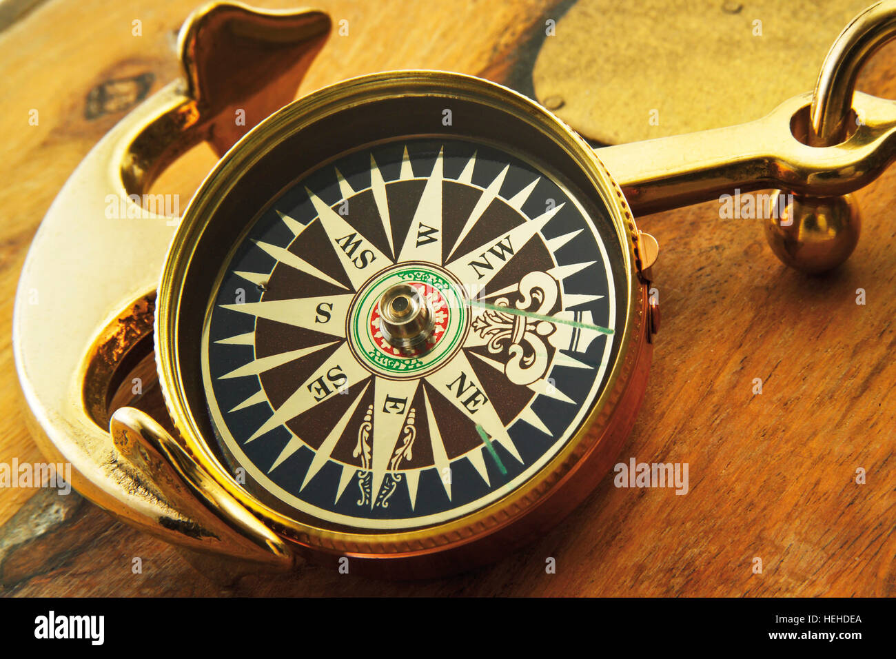 Ship's compass and golden anchor Stock Photo Alamy