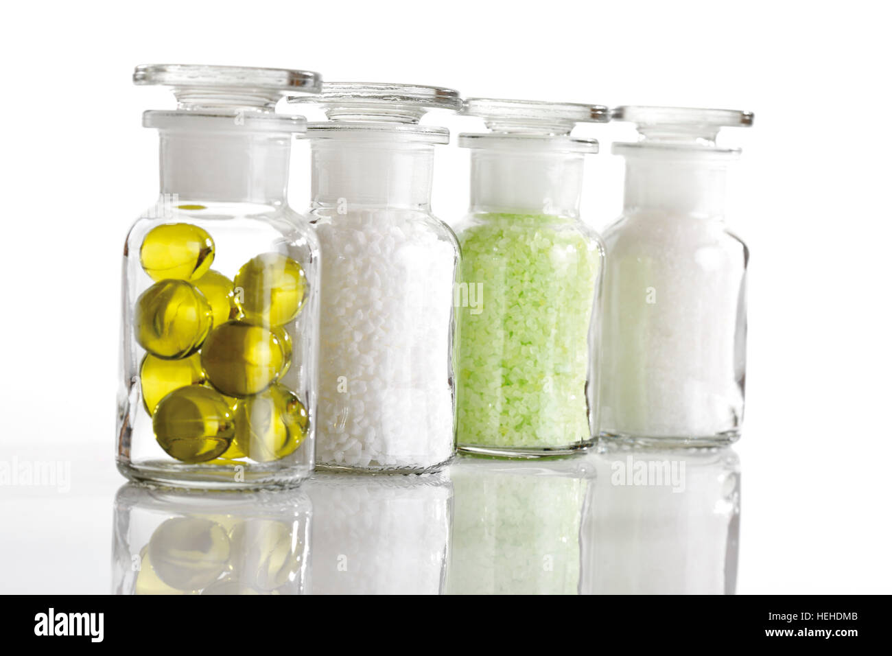 Glass bottles containing bath additives including golden bath oil beads