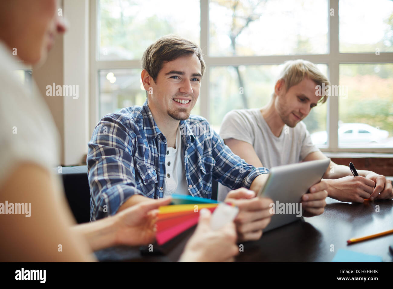 Young specialist listening to coach at lesson or conference Stock Photo