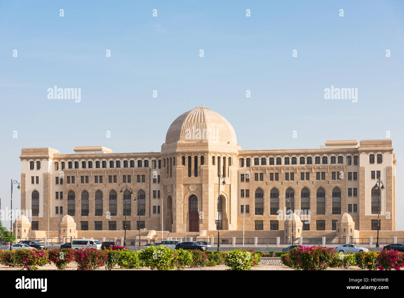 The Supreme Court of Oman in Muscat, The Sultanate of Oman. Cars in the foreground are blurred due to motion. Stock Photo