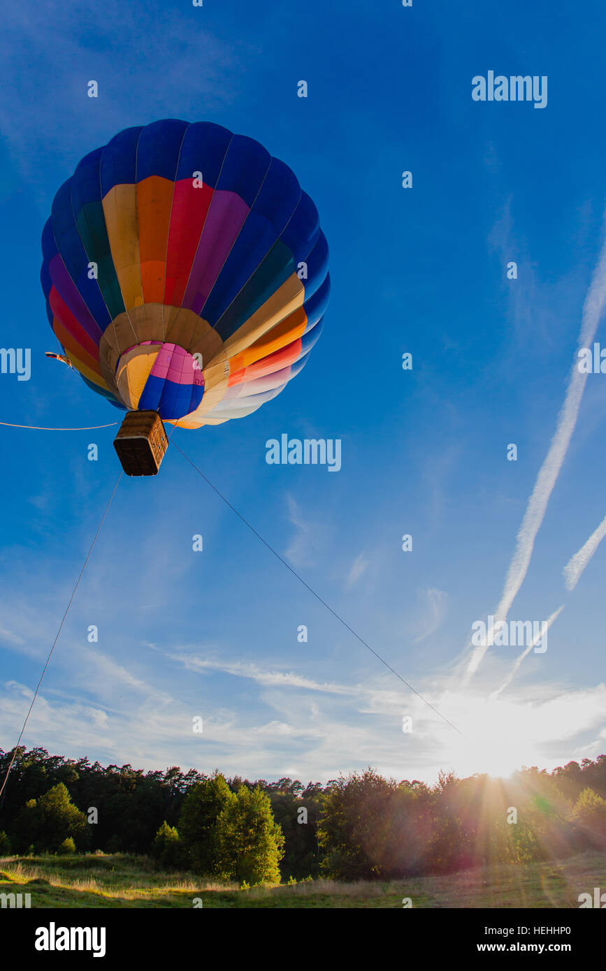 Colorful hot air balloon in blue sky at sunset Stock Photo - Alamy