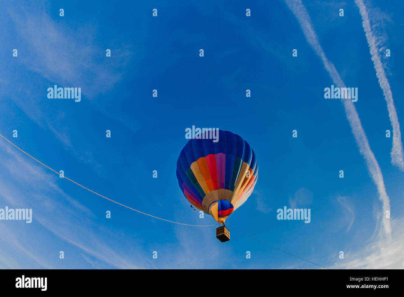 Colorful hot air balloon in blue sky at sunset Stock Photo - Alamy