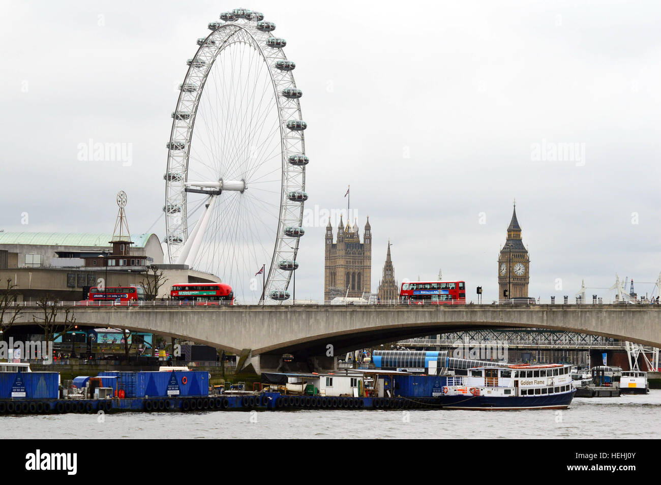 London: Big Ben, red buses and London eye. Landscape view of Westminster bridge seen from the opposite bank of the River Thames Stock Photo