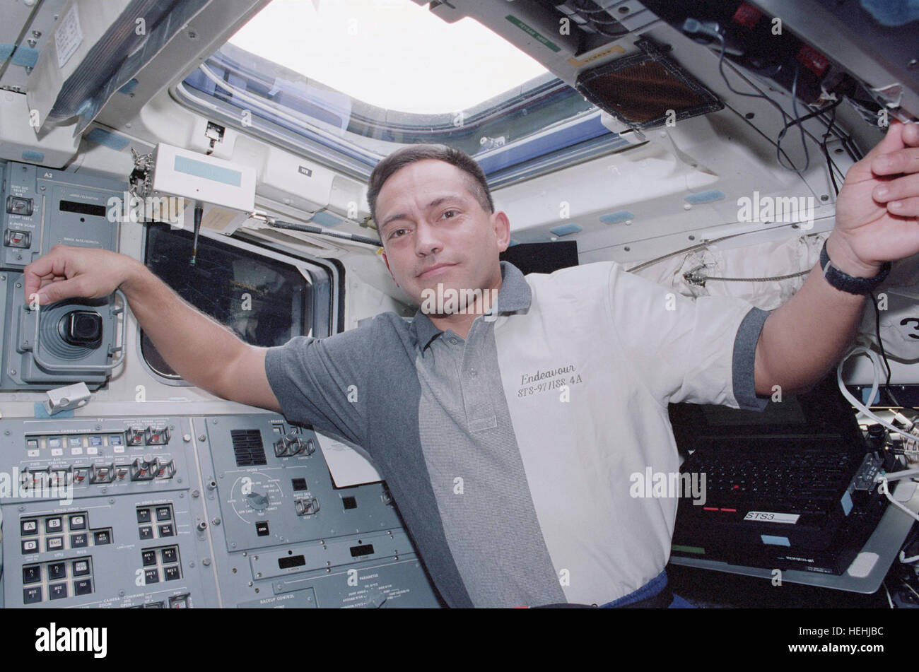 NASA STS-97 mission astronaut Carlos Noriega works on the Micro ...