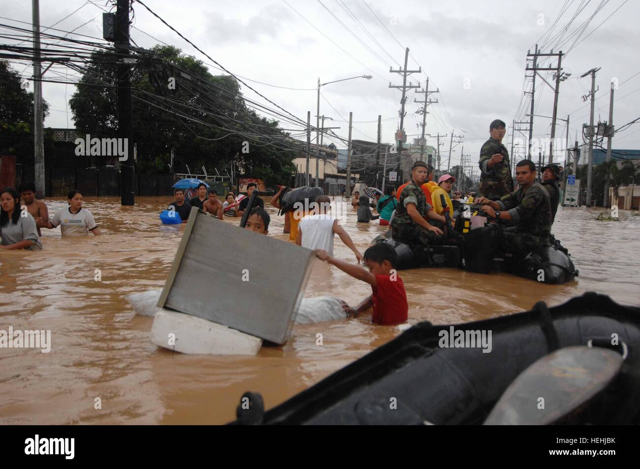 U.S. Navy SEAL soldiers rescue local residents from flood waters after flooding destroyed homes and displaced thousands of people September 17, 2007 in Manila, Philippines. Stock Photo
