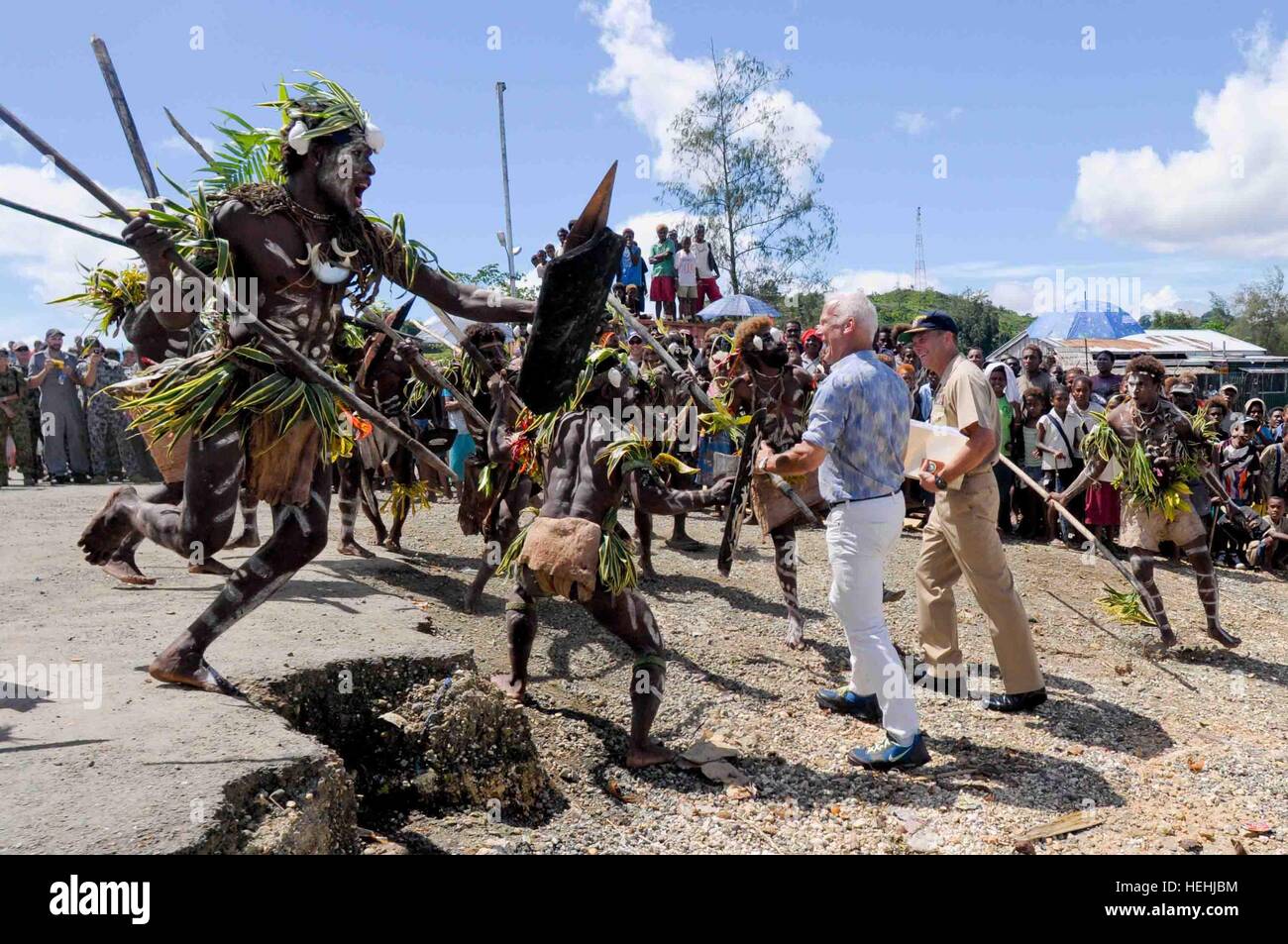 Pacific Partnership Mission Commander Andrew Cully and U.S. Charge d'Affaires Paul Berg receive a traditional warriors welcome from the Malaita Island tribe villagers during a Pacific Partnership humanitarian event August 10, 2009 in Auki, Solomon Islands. Stock Photo