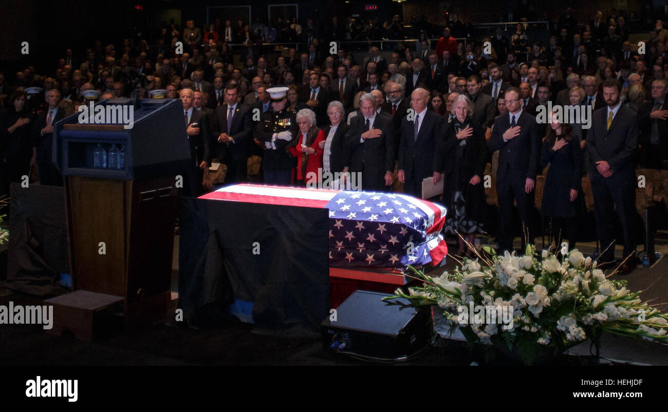 The crowd stands and bow their heads for a moment of silence during the memorial service celebrating the life of former NASA astronaut and U.S. Senator John Glenn at the Ohio State University Mershon Auditorium December 17, 2016 in Columbus, Ohio. Stock Photo