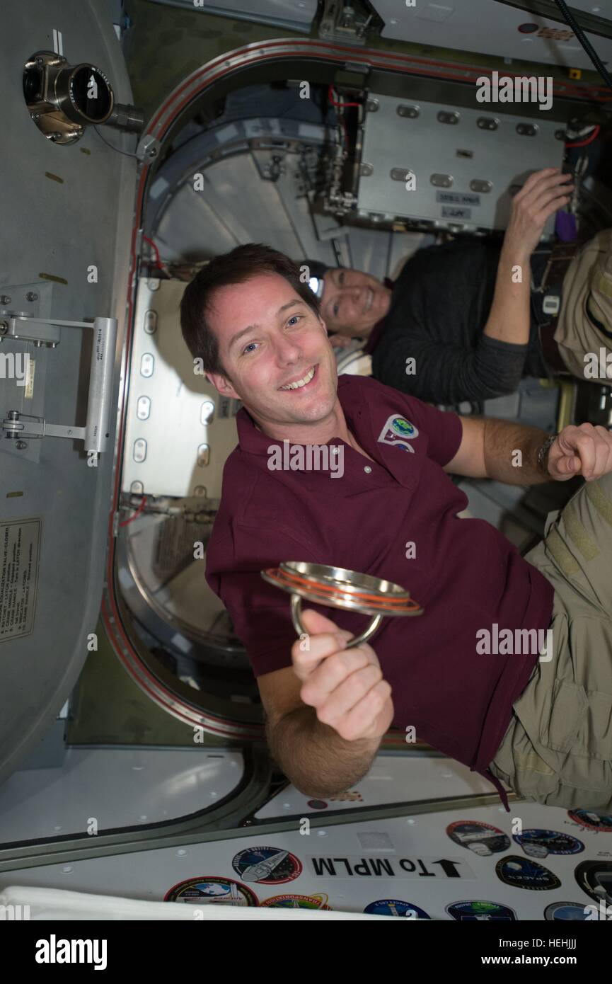 NASA Expedition 50 prime crew member French astronaut Thomas Pesquet of the European Space Agency works inside the International Space Station Harmony module to open the hatchway for the Japanese HTV-6 cargo craft December 13, 2016 in Earth orbit. Launched from the Tanegashima Space Center, HTV-6 arrived at the space station with more than 4.5 tons of supplies. Stock Photo