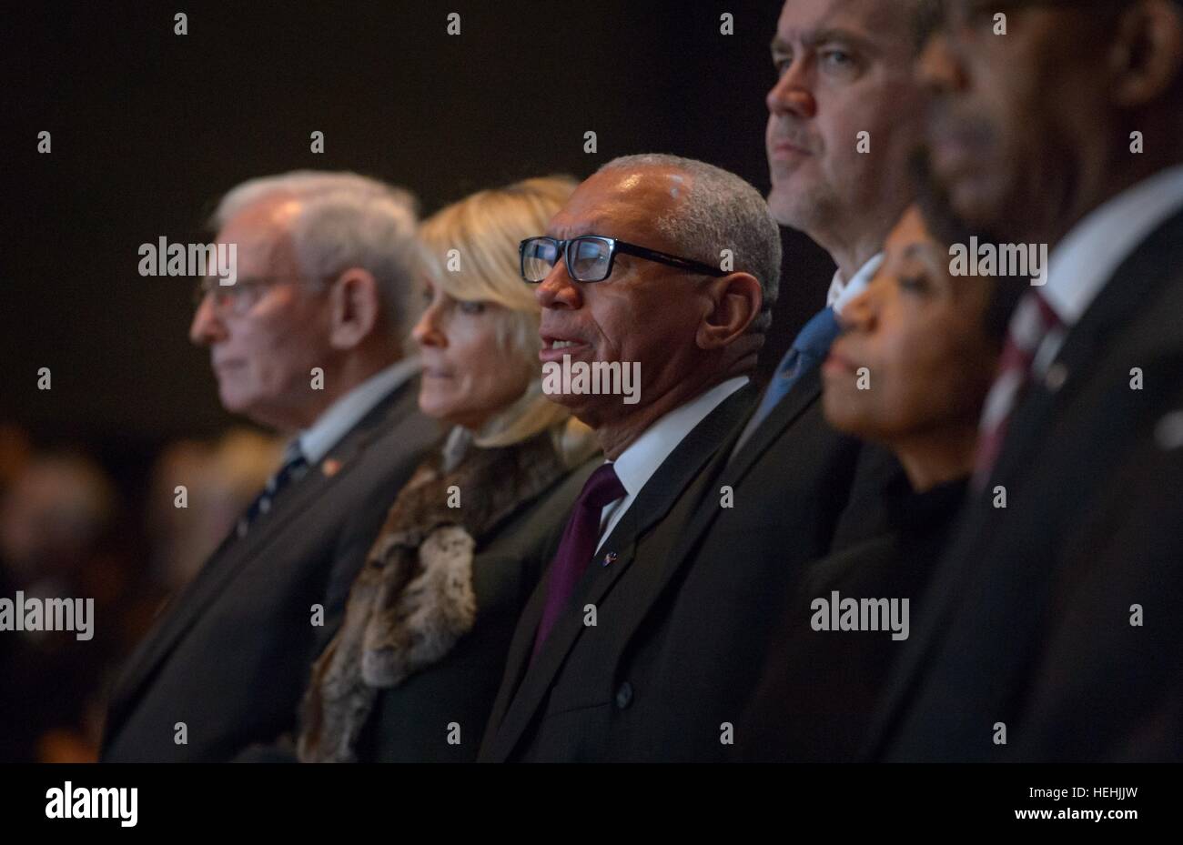 Smithsonian National Air and Space Museum Director Jack Dailey (left), Neil Armstrongs widow Carol Armstrong (middle), and NASA Administrator Charles Bolden sing along with the choir during the memorial service celebrating the life of former NASA astronaut and U.S. Senator John Glenn at the Ohio State University Mershon Auditorium December 17, 2016 in Columbus, Ohio. Stock Photo