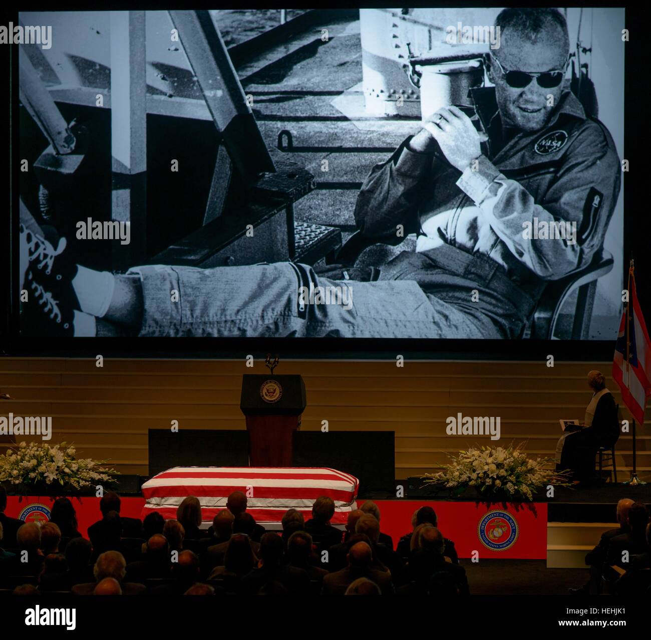 A lifetime of photos play on a large projector while friends and family gather to celebrate the life of former NASA astronaut and U.S. Senator John Glenn during a memorial service at the Ohio State University Mershon Auditorium December 17, 2016 in Columbus, Ohio. Stock Photo