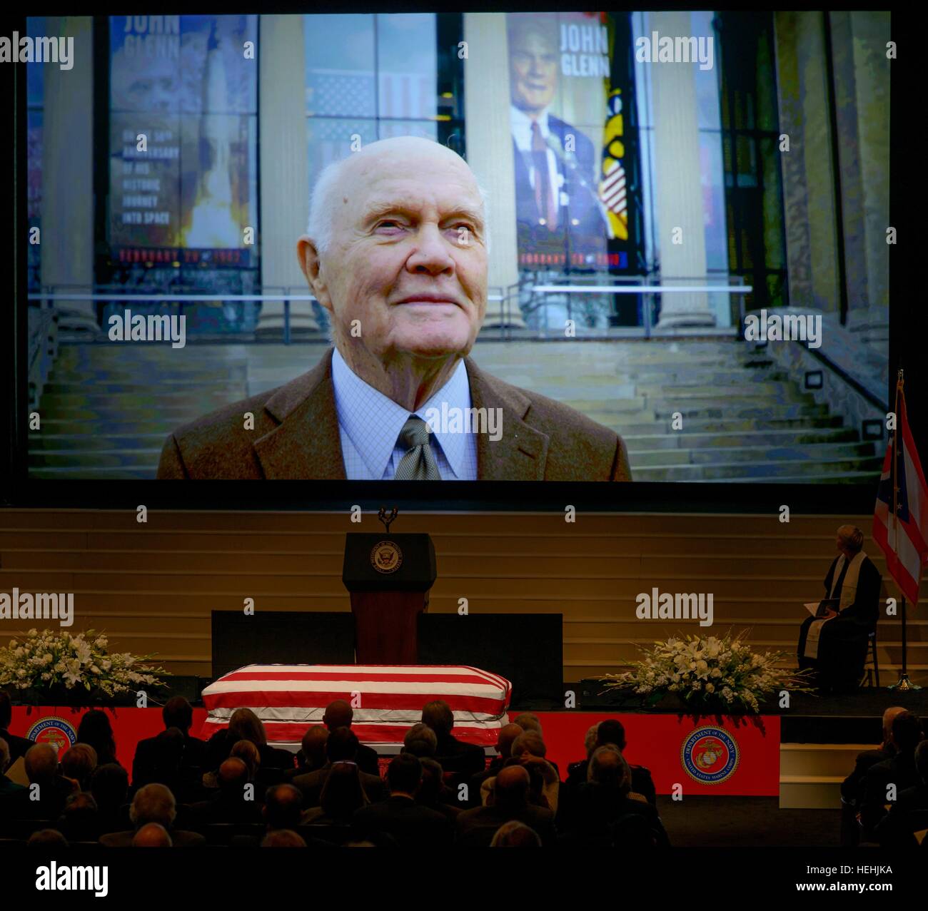 A lifetime of photos play on a large projector while friends and family gather to celebrate the life of former NASA astronaut and U.S. Senator John Glenn during a memorial service at the Ohio State University Mershon Auditorium December 17, 2016 in Columbus, Ohio. Stock Photo