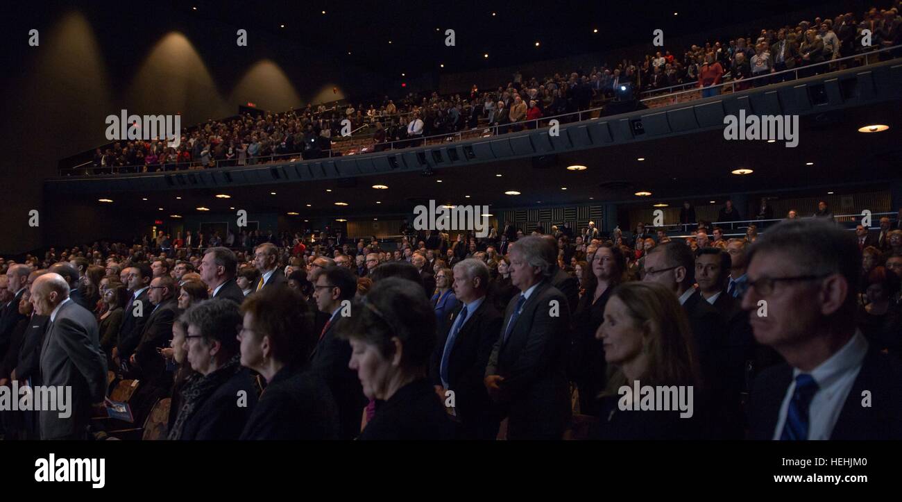 The crowd stands and bow their heads for a moment of silence during the memorial service celebrating the life of former NASA astronaut and U.S. Senator John Glenn at the Ohio State University Mershon Auditorium December 17, 2016 in Columbus, Ohio. Stock Photo