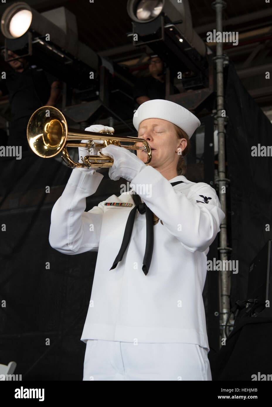 A U.S. Pacific Fleet Band member performs Taps on a bugle during the 75th Commemoration Event of the attacks on Pearl Harbor at the Joint Base Pearl Harbor-Hickam December 7, 2016 in Pearl Harbor, Hawaii. Stock Photo