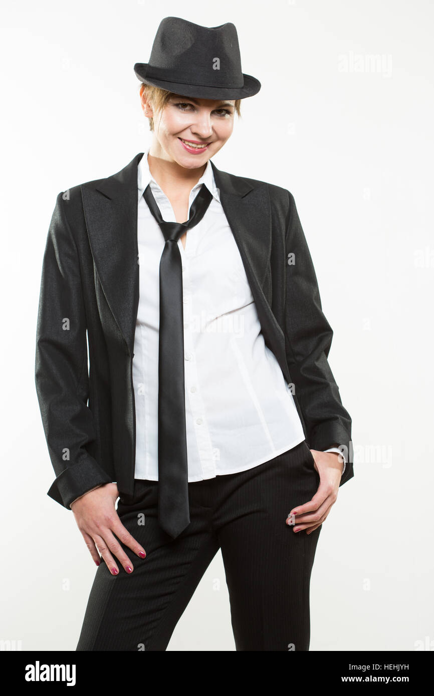 Beautiful young woman posing in business suit and hat Stock Photo - Alamy