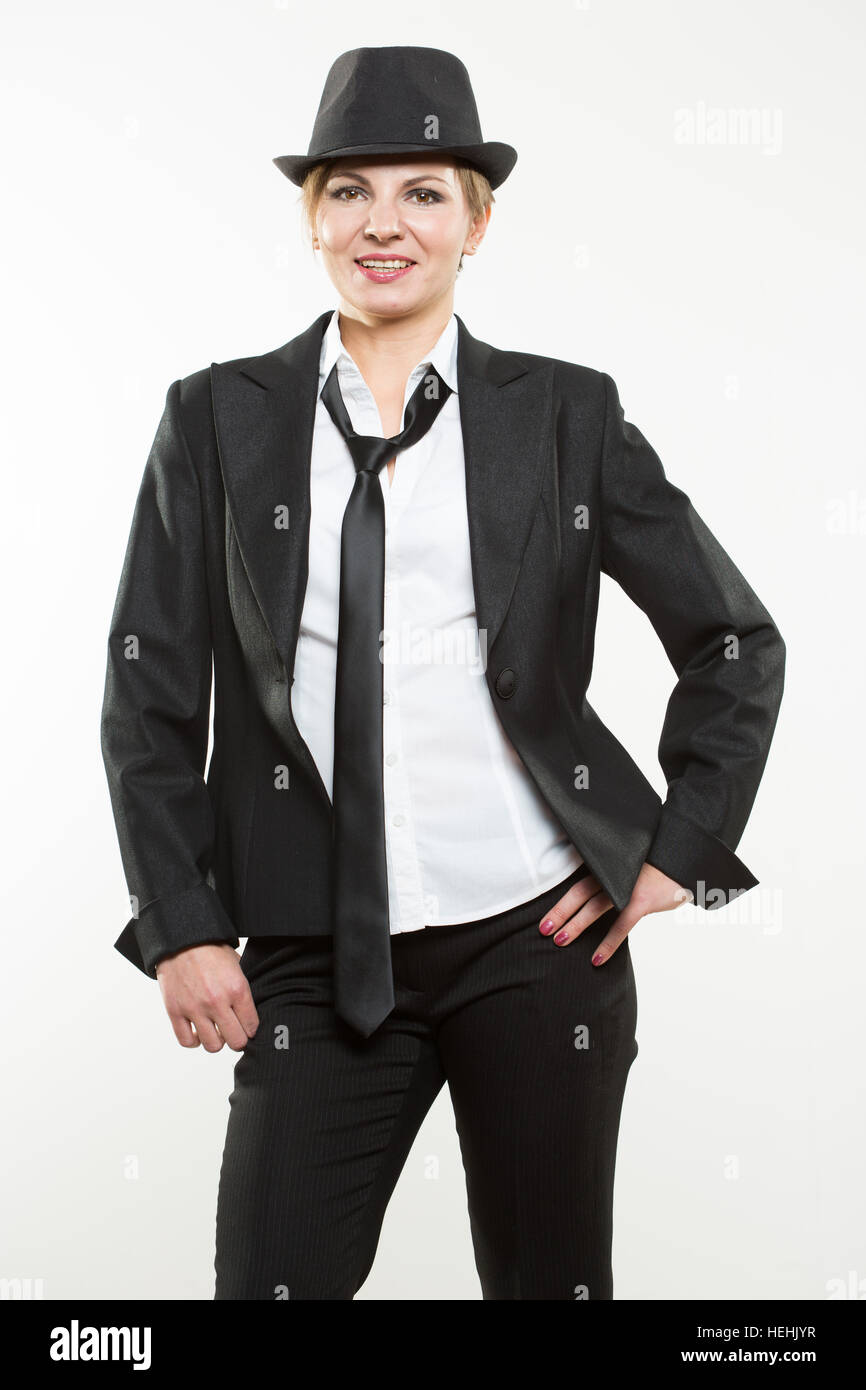 Beautiful young woman posing in business suit and hat Stock Photo - Alamy
