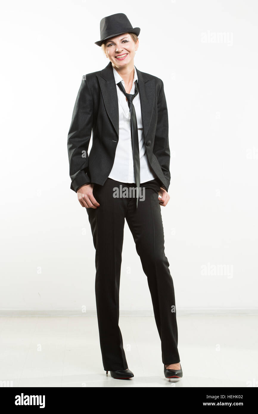 Beautiful young woman posing in business suit and hat Stock Photo - Alamy
