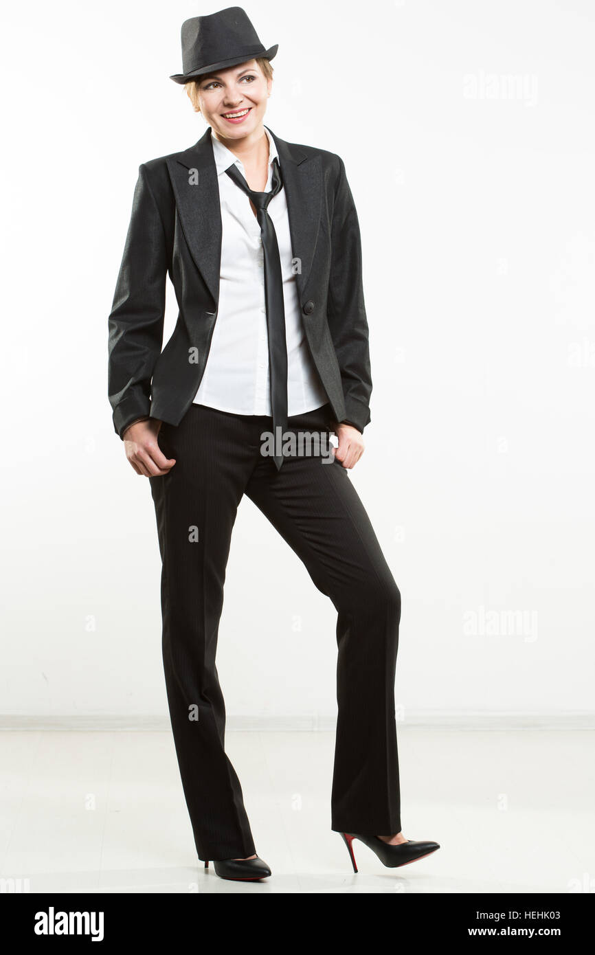 Beautiful young woman posing in business suit and hat Stock Photo - Alamy