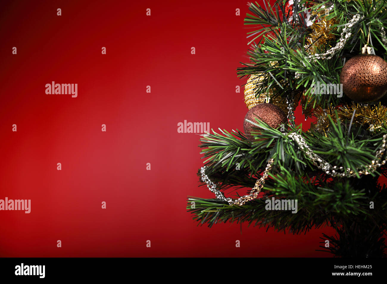 Beautiful Christmas green tree with ball on the branches and red ribbon ...