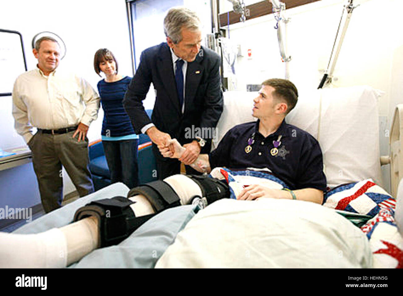 President George W. Bush shakes hands with U.S. Army Staff Sgt.  Kyle Stipp of Avon, Ind., after presenting him with two Purple Hearts Monday, Dec. 22, 2008, during a visit to Walter Reed Army Medical Center where the soldier is recovering from wounds suffered in Operation Iraqi Freedom.   White House photo by Eric Draper. Flickr - The U.S. Army - www.Army.mil (135) Stock Photo