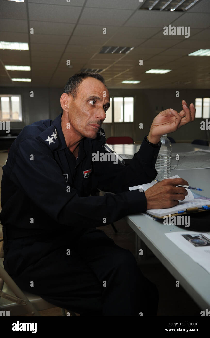 An Iraqi Army soldier reviews his notes prior to the beginning of a joint briefing between U.S. Army, Iraqi Security Forces, Iraqi Ministry of Human Rights, U.S. Embassy Iraq, United Kingdom Embassy, and Kuwait Embassy in Camp Mittica, Iraq, Dec. 19, 2010. A joint briefing was held to coordinate an upcoming mission involving the exhuming and delivery, to respective families, the bodies of Kuwaiti and Iraqi civilians at a suspected mass grave site in An Nasiriyah, Iraq. Joint Briefing at Camp Mittica 357856 Stock Photo