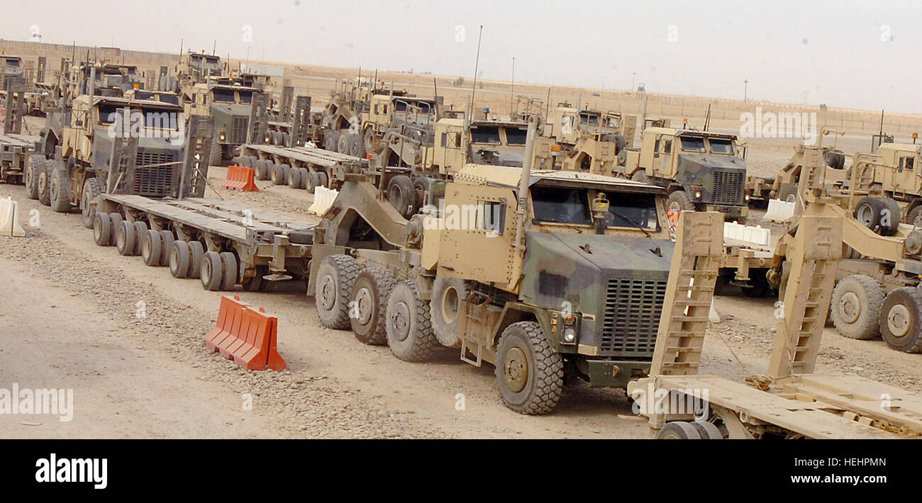 Heavy Equipment Transport military vehicles split into lanes in preparation for mission on