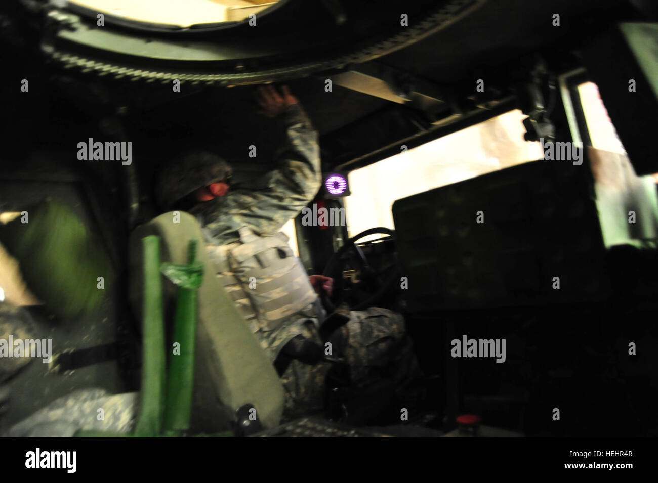 Soldiers train in the Humvee Egress Assistance Trainer (HEAT) to safely ...