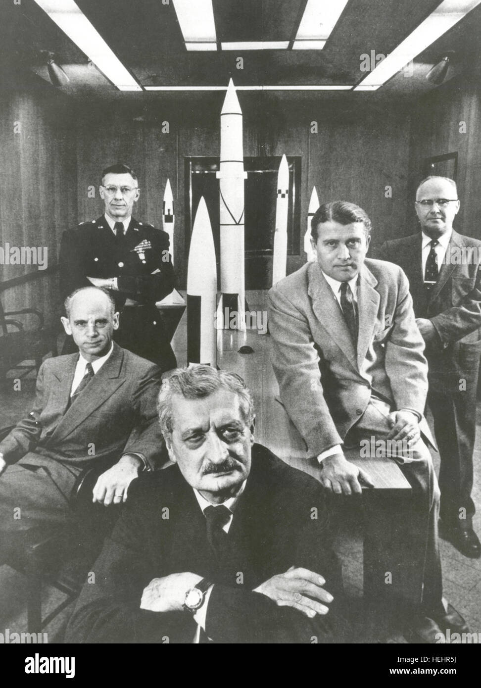 Hermann Oberth (forefront) with officials of the Army Ballistic Missile Agency at Huntsville, Alabama in 1956. Left to right around Oberth: 1) Dr. Ernst Stuhlinger (seated). 2) Major General H.N. Toftoy, Commanding Officer and person responsible for 'Project Paperclip,' which took scientists and engineers out of Germany after World War II to design rockets for American military use. Many of the scientists later helped to design the Saturn V rocket that took the Apollo 11 astronauts to the Moon. 3) Dr. Robert Lusser, a Project Paperclip engineer who returned to Germany in 1959. (Note: Lusser is Stock Photo