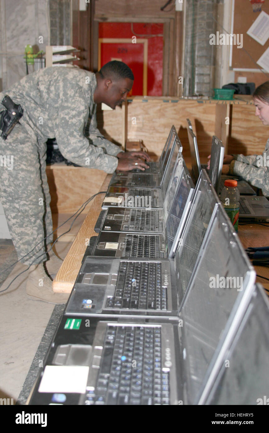 Photo by 1SG David Moore/JASC Public Affairs.  Staff Sgt. Jarod J. Gatson checks computer status and surveys progress of  reimaging the first 30 0of of 400 computers on March 14 that results in the removal of tactical servers from FOB Prosperity. Joint Area Support Group - Central Soldiers Keep Connected 166981 Stock Photo