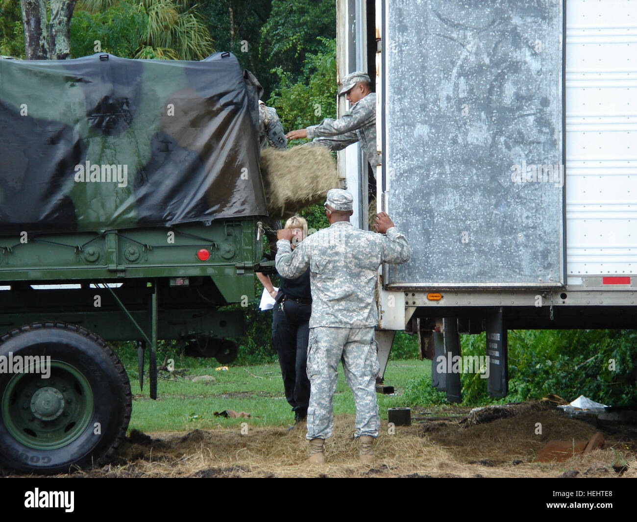 Members of the 2nd Battalion of the 124th Infantry Regiment help a ...