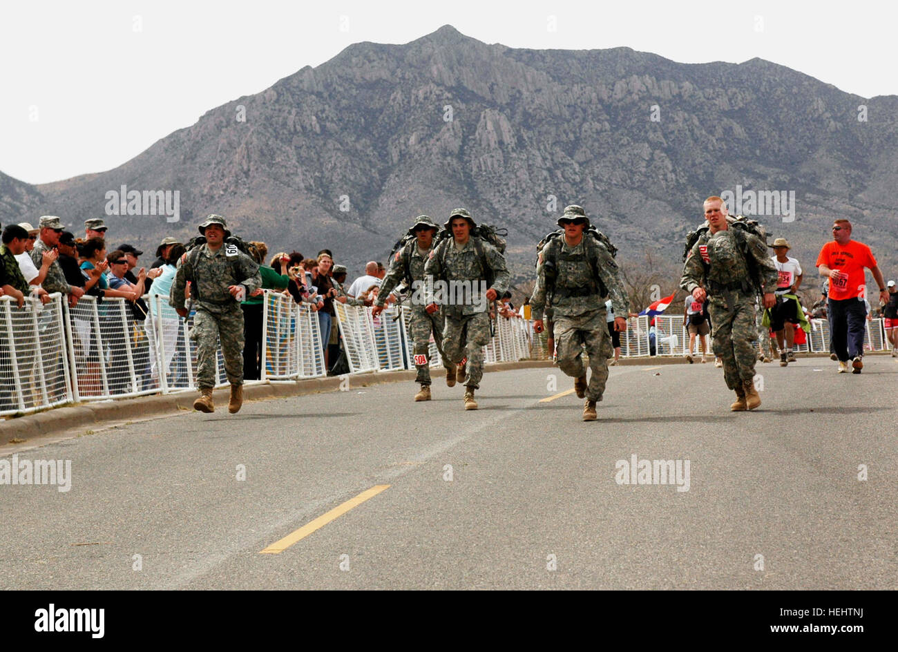Team Juggernaut, made up of five soldiers from Green Bay-based Company B, 2-127th Infantry, crosses the finish line in first place in the National Guard Heavy category at the 20th Annual Bataan Memorial Death March marathon, White Sands Missile Range, N.M., March 29. Team members are Spc. Andrew Vannieuwehoven, Green Bay; Pfc. Jesse Tlachac, Sturgeon Bay; Sgt. Ryan Gries, Madison; Pfc. Eric Sallenbach, Green Bay and Pfc. Kyle Cooper, Appleton. Bataan Memorial Death March Honors World War II Soldiers 162256 Stock Photo