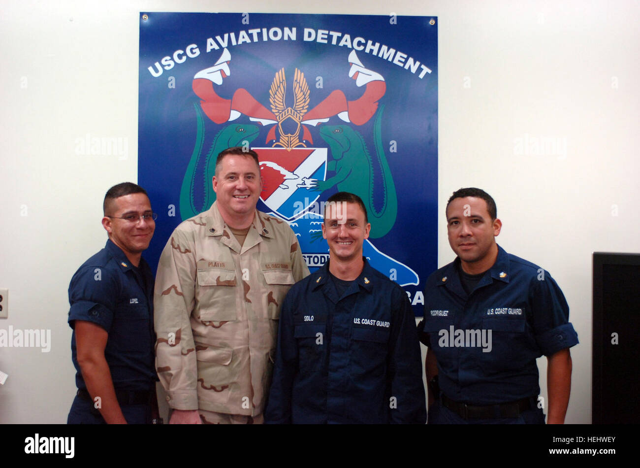 GUANTANAMO BAY, Cuba – Aviation detachment members; Coast Guard Petty Officer 2nd Class Anthony Lopez, Petty Officer 1st Class John Platts, Chief Petty Officer Corey Sidlo and Petty Officer  2nd Class Carlos Rodriguez, pose for a picture, April 20, 2009. The aviation detachment, which is stationed at Joint Task Force Guantanamo, is part of U.S. Coast Guard Air Station Miami. JTF Guantanamo conducts safe, humane, legal and transparent care and custody of detainees, including those convicted by military commission and those ordered released. The JTF conducts intelligence collection, analysis and Stock Photo