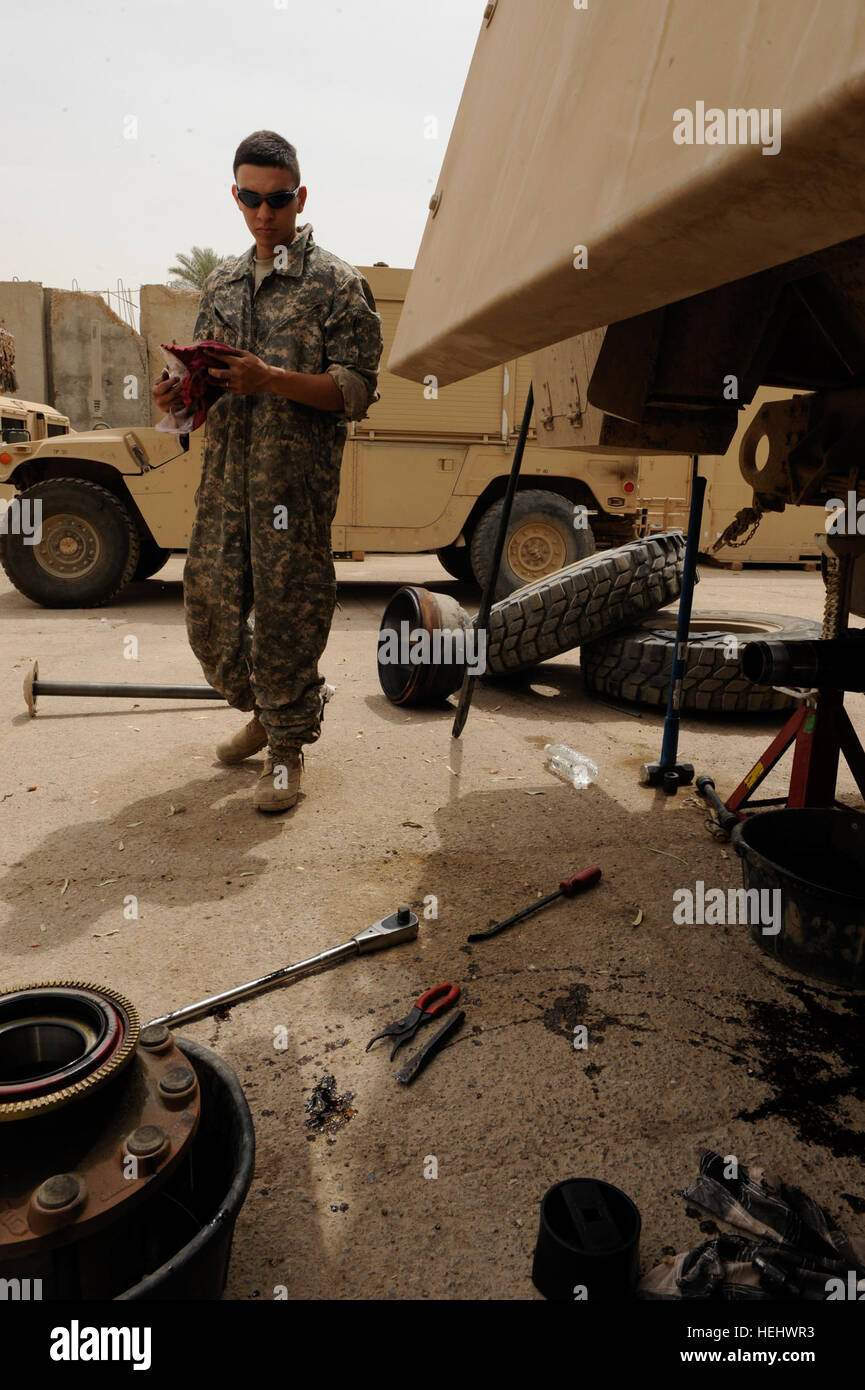 U.S. Army Spc. Arthur Guevara from San Antonio, Texas, of 1st Battalion, 5th Cavalry Regiment, 1st Brigade Combat Team, 1st Cavalry Division, performs vehicle maintenance on a Mine Resistant Ambush Protected Armored Fighting Vehicle at Joint Security Station War Eagle in Baghdad, Iraq, on April 29. Cavalry Soldiers keep key vehicles maintained 168847 Stock Photo