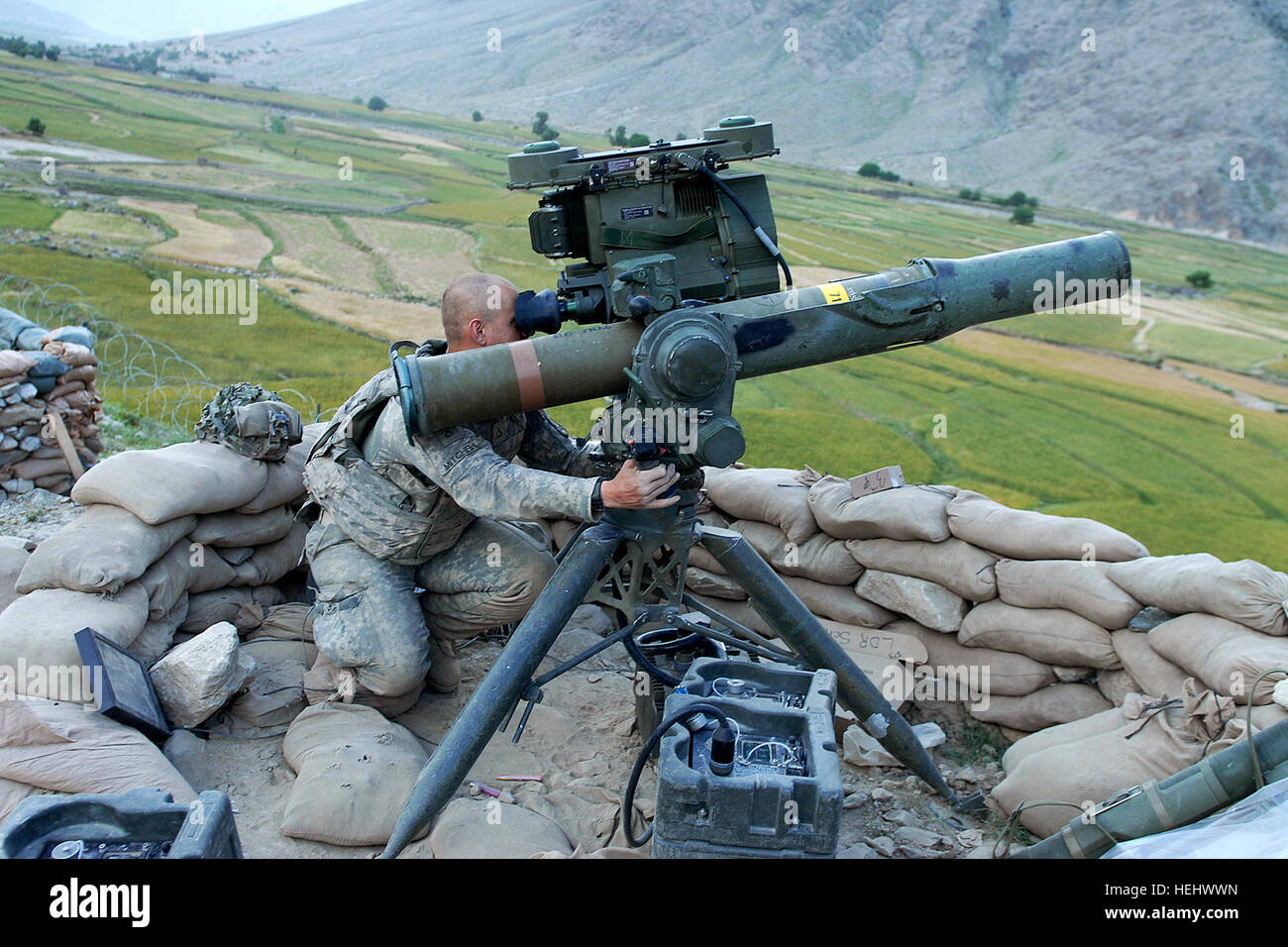 Army Pfc. David Mitchell, a Soldier with 1st Battalion, 32nd Infantry Battalion, scans the landscape surrounding Vehicle Patrol Base Badel, located at the mouth of the Narang Valley in Konar Province.  The base has closed down a large amount of enemy activity in the valley and in the districts of Narang, Chowkay and Nurgal. (U.S. Army photo by Sgt. Amber Robinson) Hires 090509-A-4842R-001a Stock Photo