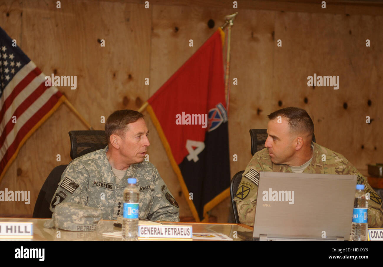 LOGAR Province, Afghanistan - U.S. Army Gen. David H. Petraeus (left), International Security Assistance Force commanding general from Cornwall on Hudson, N.Y., discusses 4th Brigade Combat Team, 10th Mountain Division operations with U.S. Army Col. Bruce P. Antonia, commander of from Manchester, Conn., 4th BCT, 10th Mtn. Div. Task Force Patriot commander from Manchester, Conn., during a briefing on Forward Operating Base Shank, Afghanistan, Christmas Eve. Petraeus visits TF Patriot, attends candlelight service 353294 Stock Photo