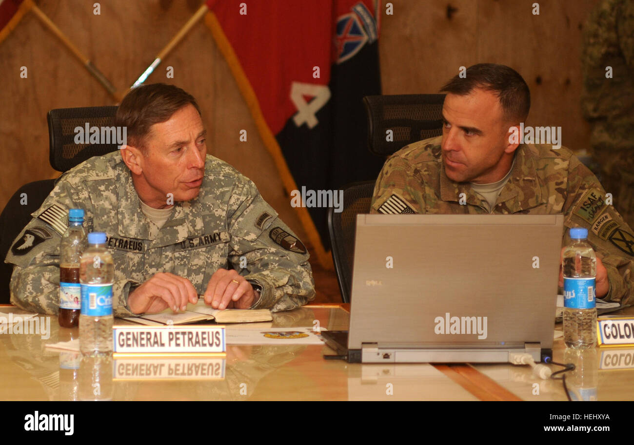 U.S. Army Gen. David H. Petraeus (left), International Security Assistance Force commanding general from Cornwall on Hudson, N.Y., discusses 4th Brigade Combat Team, 10th Mountain Division operations with U.S. Army Col. Bruce P. Antonia, 4th BCT, 10th Mtn. Div. Task Force Patriot commander from Manchester, Conn., during a briefing on Forward Operating Base Shank, Dec. 24. (Photo by U.S. Army Sgt. 1st Class Matt Meadows, Task Force Patriot Public Affairs) Petraeus visits TF Patriot, attends candlelight service 353295 Stock Photo