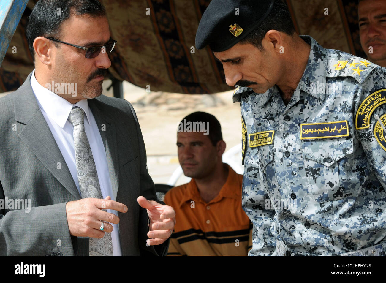 Iraqi national police Brig. Gen. Ali Ibraheem Dabown (right), commander of 8th Brigade, 2nd Division, listens to a representative of the Iraqi Ministry of the Interior during a transfer of authority ceremony of Joint Security Station Oubaidy, in eastern Baghdad, Iraq, on June 20. Control of the joint security station is being transferred from the U.S. Army, 2nd Battalion, 505th Infantry Regiment, 3rd Brigade Combat Team, 82nd Airborne Division to the government of Iraq. Transfer of authority ceremony for Joint Security Station Oubaidy 182350 Stock Photo