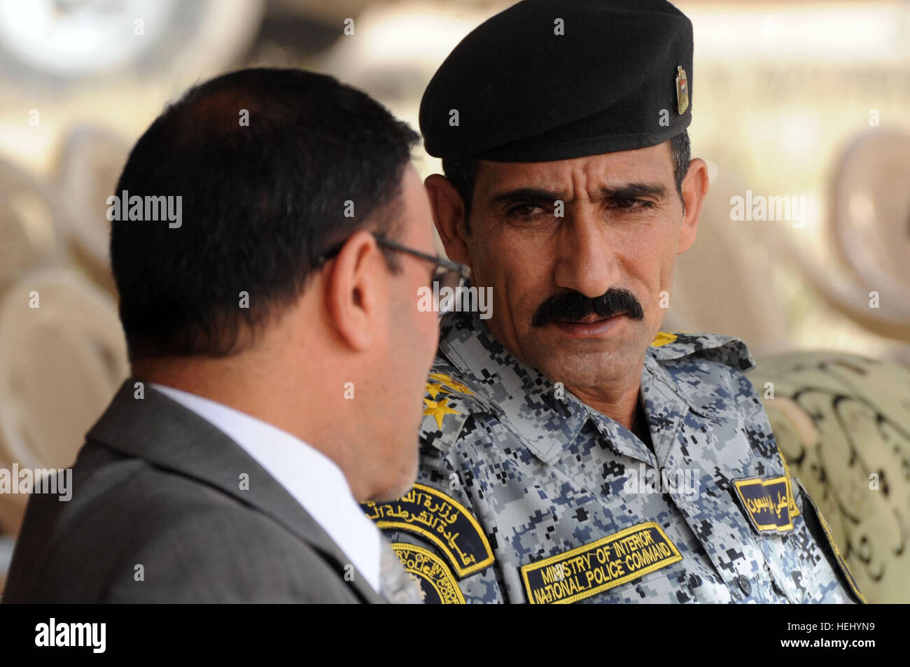 Iraqi national police Brig. Gen. Ali Ibraheem Dabown (right), commander of 8th Brigade, 2nd Division, listens to a representative of the Iraqi ministry of the Interior during a transfer of authority ceremony of Joint Security Station Oubaidy, in eastern Baghdad, Iraq, on June 20. Control of the joint security station is being transferred from the U.S. Army, 2nd Battalion, 505th Infantry Regiment, 3rd Brigade Combat Team, 82nd Airborne Division to the government of Iraq. Transfer of authority ceremony for Joint Security Station Oubaidy 182351 Stock Photo