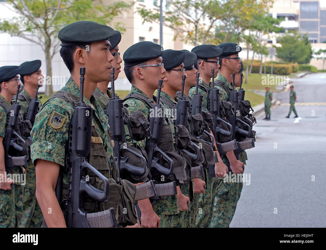 A platoon of Singapore infantry soldiers stand at attention as they