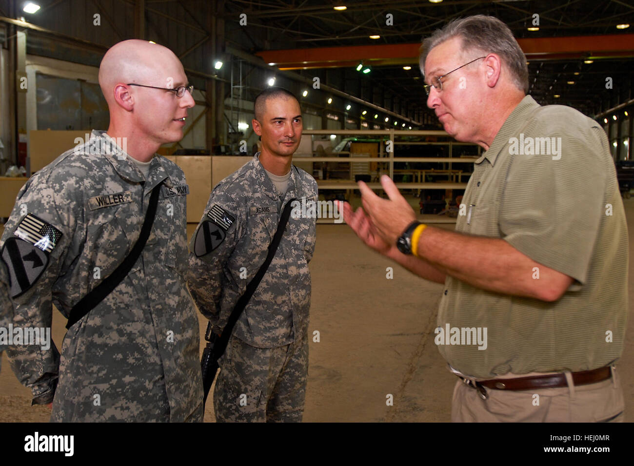 Missouri Gov. Jay Nixon, right, gestures enthusiastically as he discusses baseball with Sgt. Thomas Adams, center, from St. Louis, Mo., transportation coordinator, Headquarters Support Company, 615th Aviation Support Battalion, 1st Air Cavalry Brigade, 1st Cavalry Division, Multi-National Division - Baghdad and Spc. Scott Waller, from Steelville, Mo., armament support, Company B, 615th ASB, 1st ACB, July 18, at Camp Taji, Iraq. Nixon was part of a visit which also included governors from Illinois, Minnesota, Nevada and Texas. State governors visit 1st Air Cavalry Brigade 188839 Stock Photo
