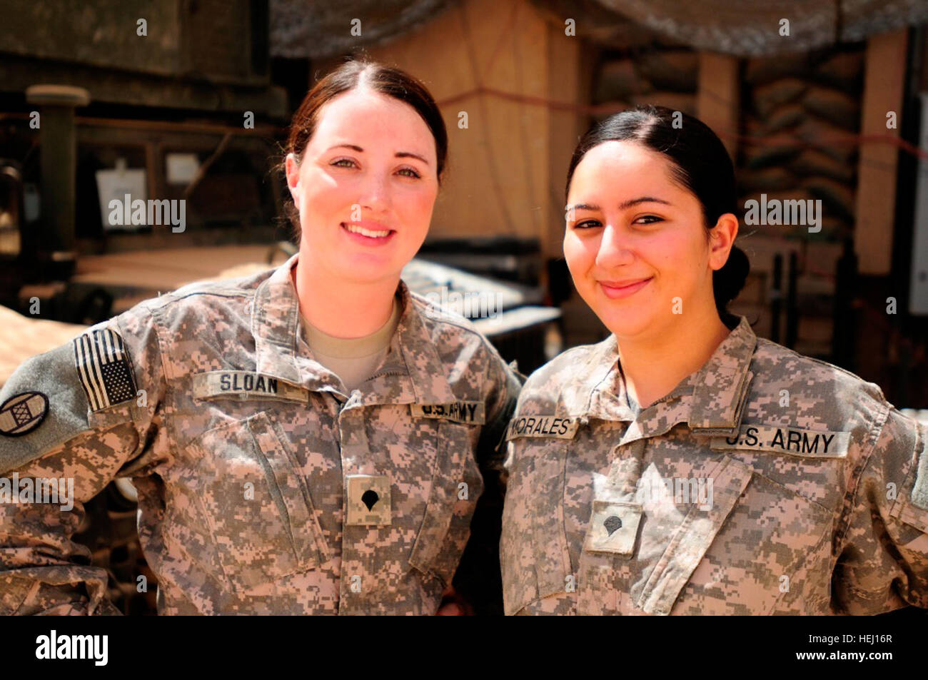 Spc. Felicia Sloan (left), of Lumberton, N.C., and Spc. Yessenia Morales, of High Point, N.C., are drivers with the personnel protection detachments that shield the 30thHeavy Brigade Combat Team's command group at Forward Operating Base Falcon. The two military policemen mainly work with infantrymen, which is traditionally a male-only field. Female Military Police 'driven' to protect 191678 Stock Photo