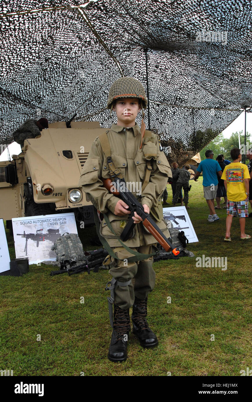 photo by Spc. Gregory Argentieri/49th PAD A young boy dressed in a old paratrooper uniform stands ready during the 69th National Airborne Day celebration at the Airborne and Special Operations Museum in downtown Fayetteville, Saturday. This young boy was not alone. Many volunteer re-enactors came out for Airborne day dressed in authentic uniforms from WWII through present day, and many displayed weapons and equipment from these bygone eras. Flickr - The U.S. Army - 69th National Airborne Day Stock Photo