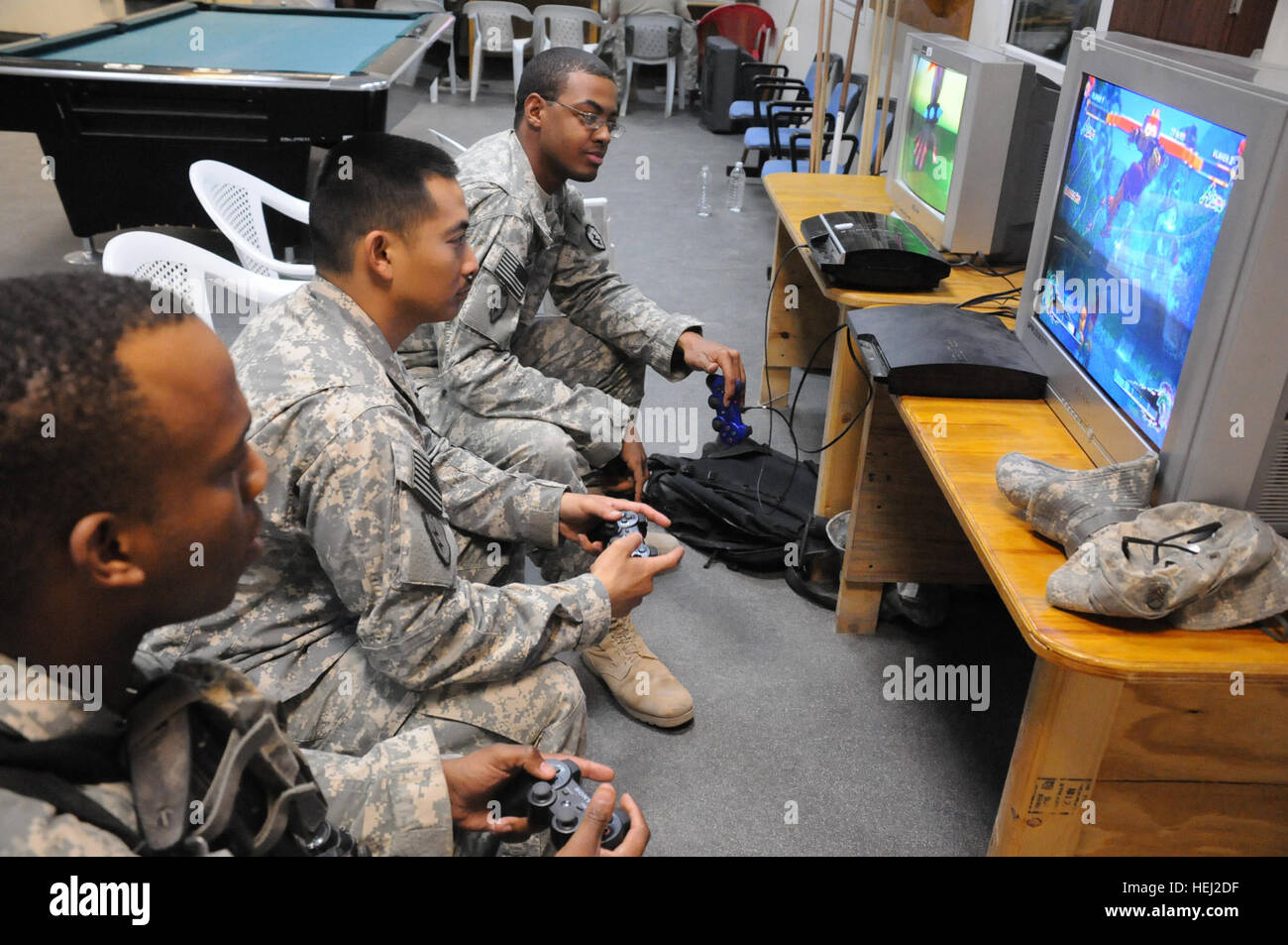 Soldiers from 2nd Advise and Assist Brigade, 25th Infantry Division, concentrate on the task at hand in the Super Street Fighter IV tournament held at Forward Operating Base Warhorse, Diyala, Iraq, Sept. 4. The tournament was open to all avid gamers on post. New king of fighters is crowned 316630 Stock Photo