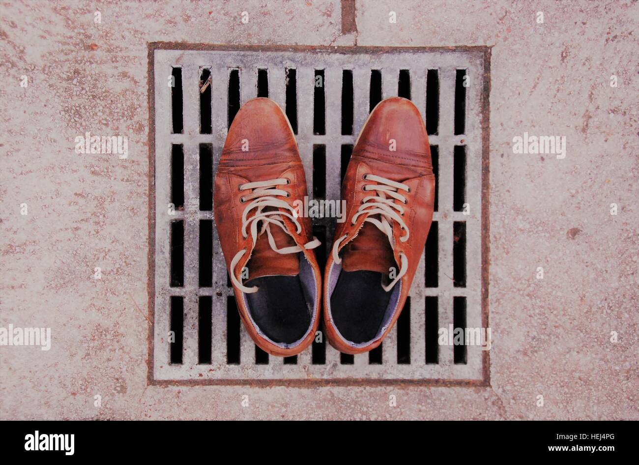 LIFE FATE-SINGLE MAN: Empty shoes on the drain Stock Photo
