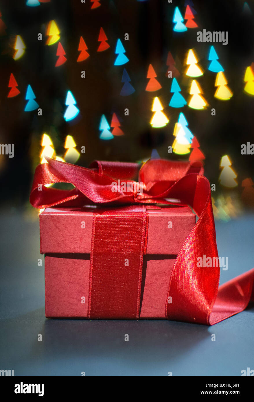 Red present box with Christmas tree shaped bokeh lights Stock Photo