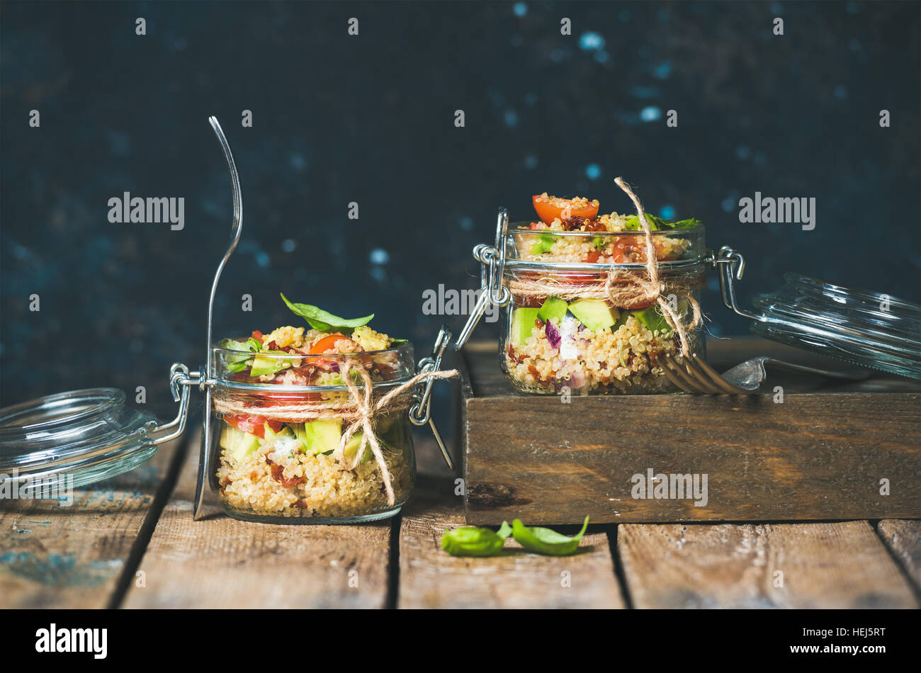 Homemade jar quinoa salad with cherry and sun-dried tomatoes, avocado Stock Photo