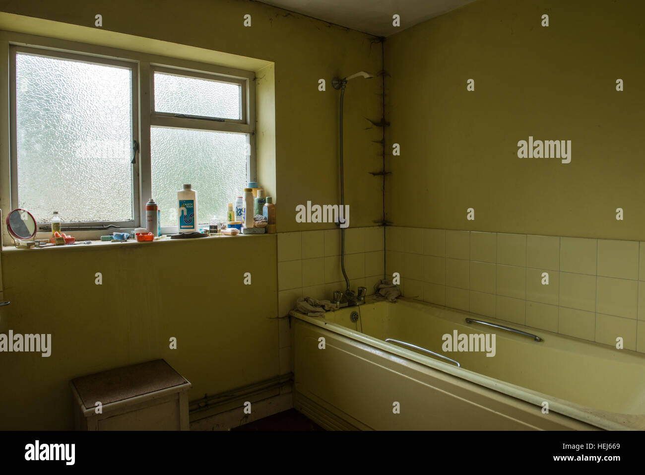 The bathroom inside an abandoned and derelict house with a small ... The bathroom inside an abandoned and derelict house with a small ...