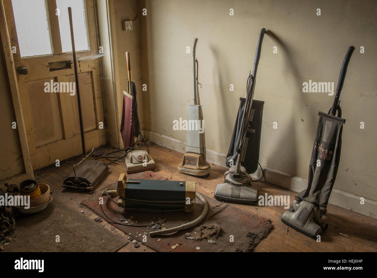 A collection of vintage vacuum cleaners inside a derelict house within Banham, Norfolk, UK Stock Photo
