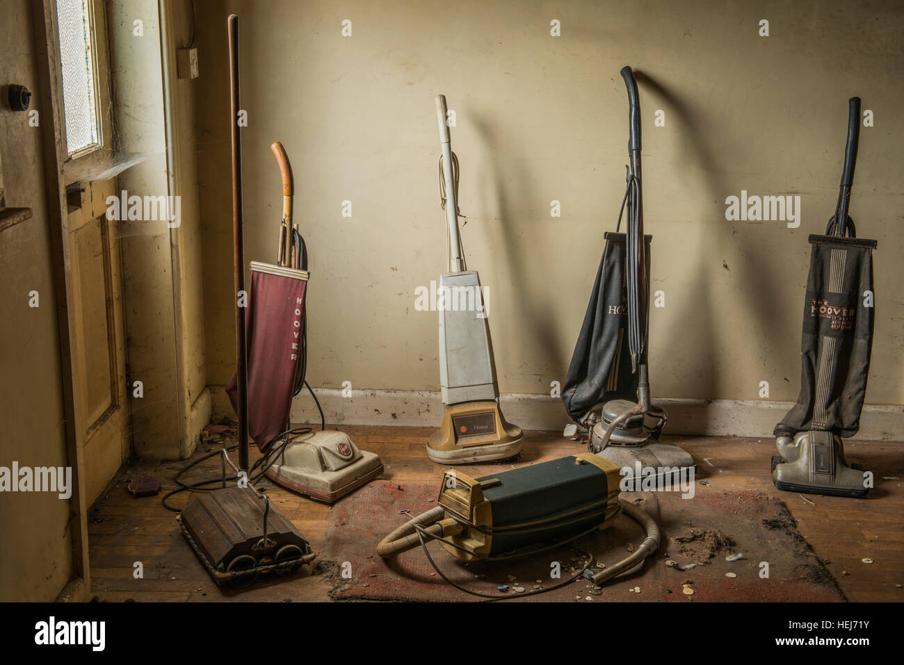 A collection of vintage vacuum cleaners inside a derelict house within Banham, Norfolk, UK Stock Photo